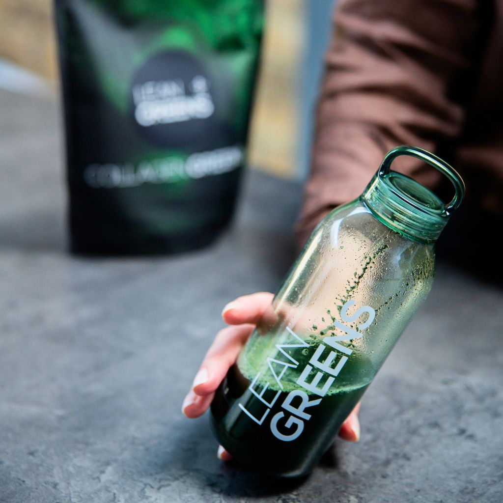 Lean Greens bottle held outdoors